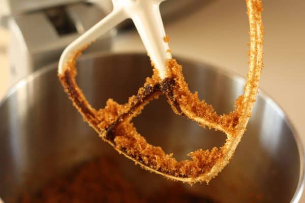 a mixer paddle hovering over a mixing bowl.
