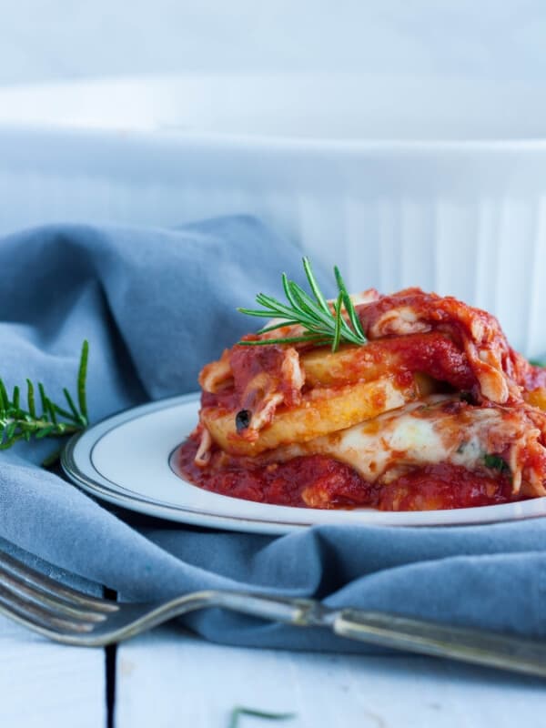 a plate of gluten free lasagna on a grey cloth