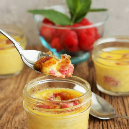 Little jars of easy creme brulee with a spoonful being lifted out