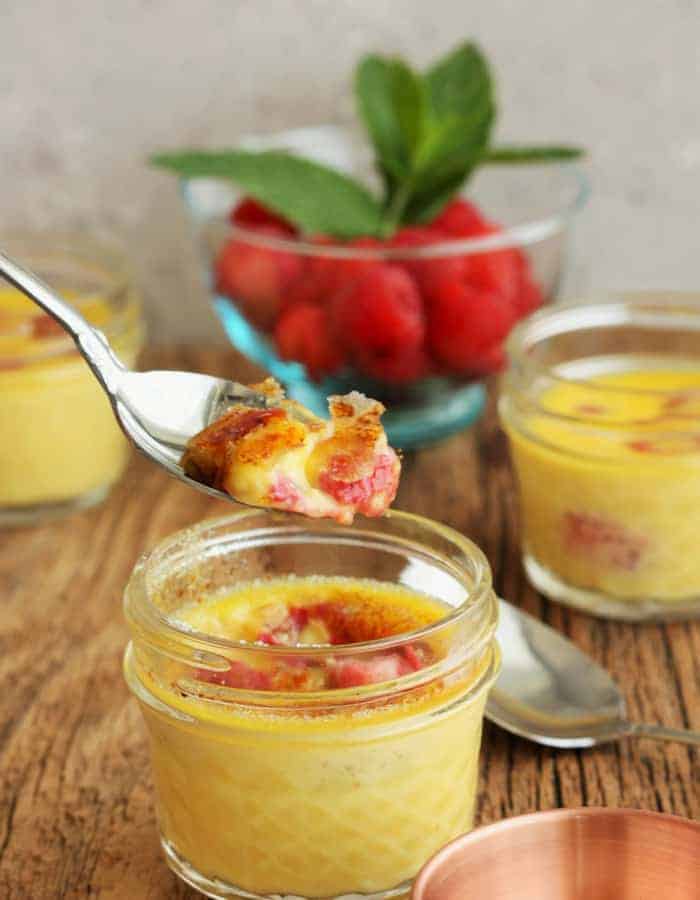 Little jars of easy creme brulee with a spoonful being lifted out