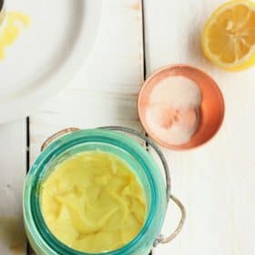 homemade mayo in a blue mason jar with salt and a lemon