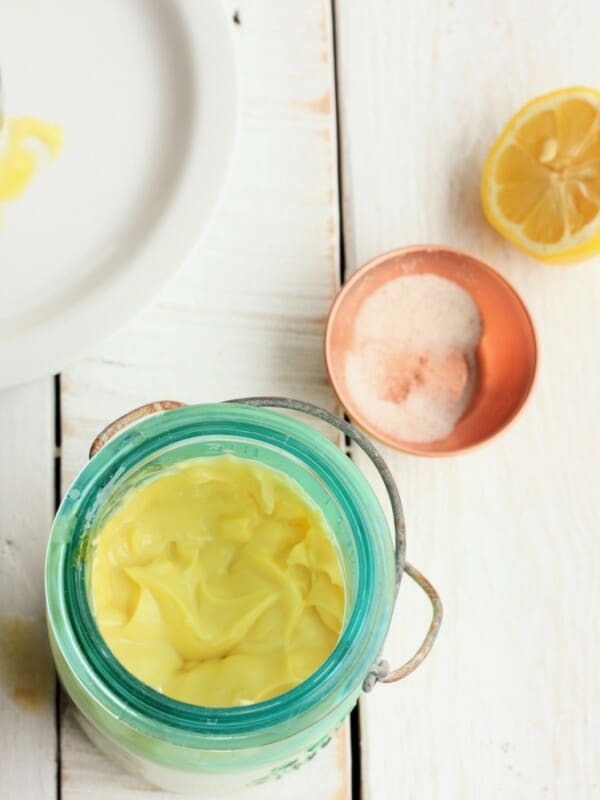 homemade mayo in a blue mason jar with salt and a lemon