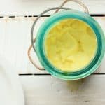 homemade mayo in a blue canning jar on a white background