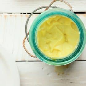 homemade mayo in a blue canning jar on a white background