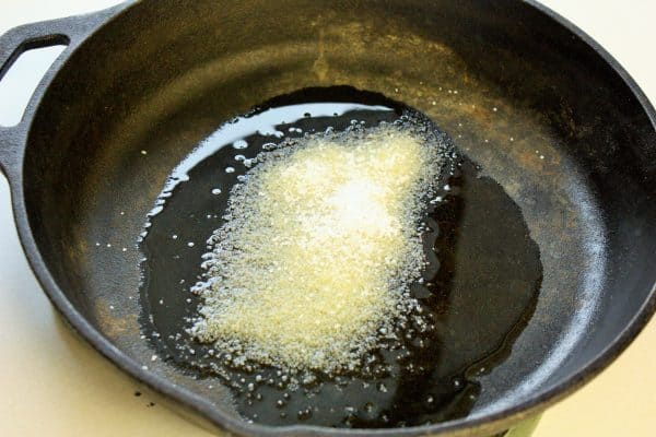 a cast iron skillet with olive oil and salt to show how to remove rust from a cast iron skillet