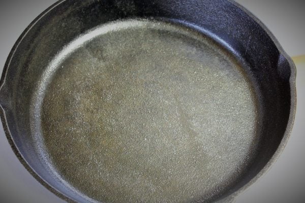 a skillet showing how to clean and season cast iron
