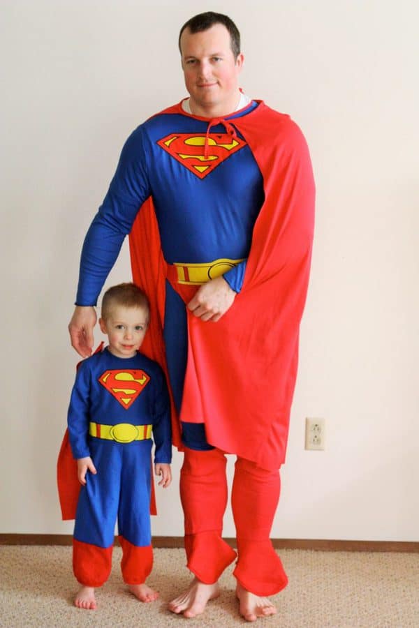 a father and son in superman costumes