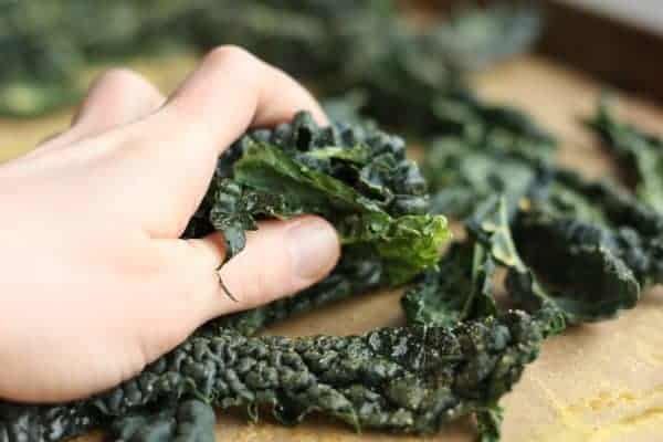 kale chips a hand massaging kale