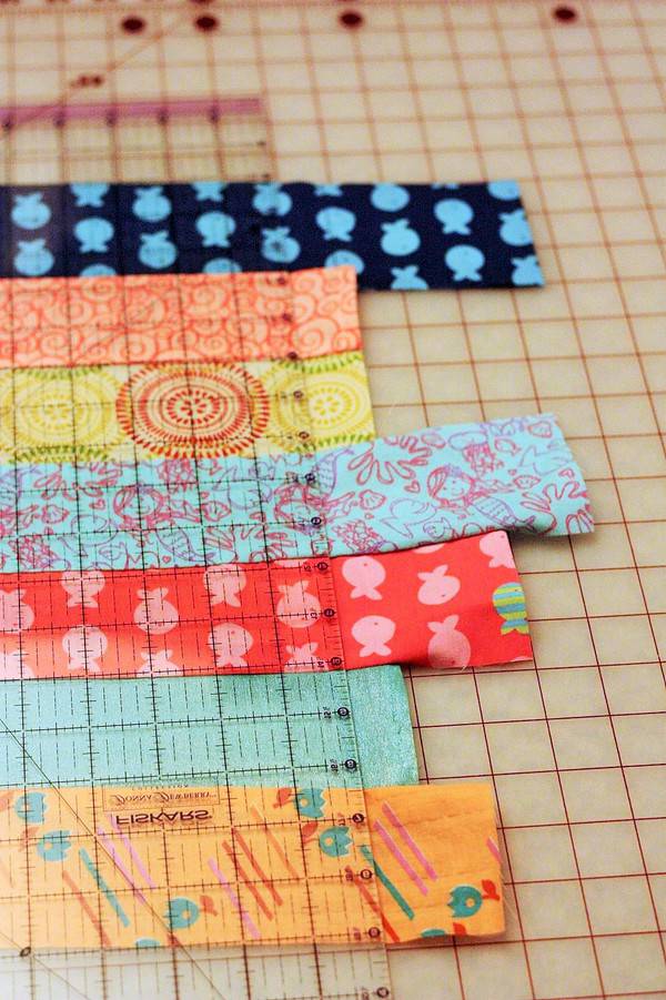 strips of fabric for beginning quilts being cut