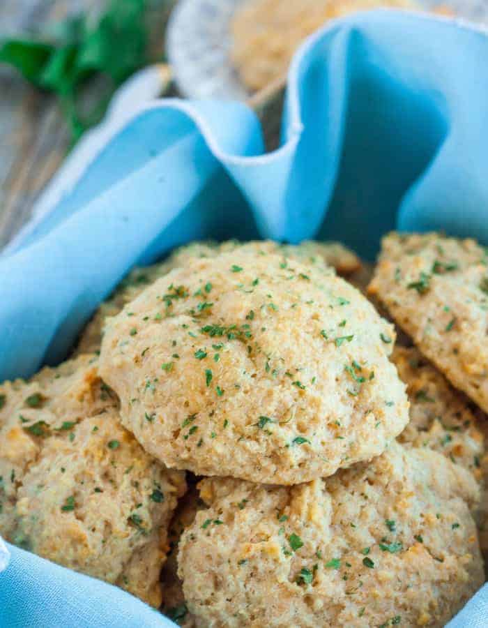 homemade red lobster cheddar bay biscuits in a basket with a blue linen