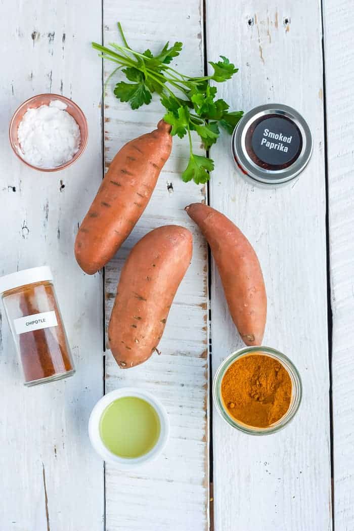 sweet potatoes, parsley, and spices for making spicy sweet potato fries