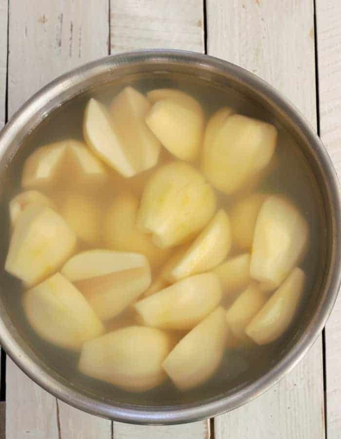A bowl of pears and lemon juice being prepped for canning 