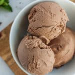 3 scoops of chocolate vegan ice cream in a white bowl