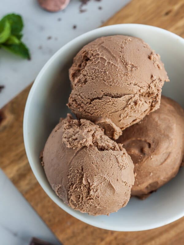 3 scoops of chocolate vegan ice cream in a white bowl