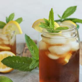Two glasses of healthy sweet tea with mint and lemons