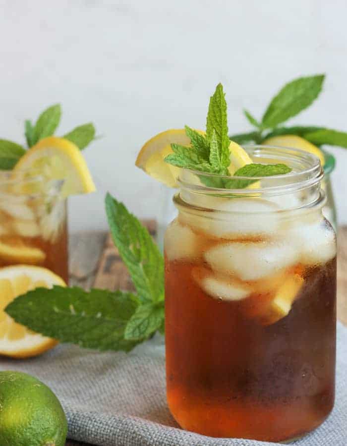 Two glasses of healthy sweet tea with mint and lemons