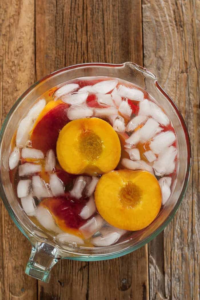 peaches in a bowl of ice water to make them easier to peel
