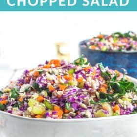 a white and blue bowl full of kale chopped salad