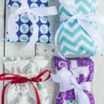4 rice heating pads with ribbons on a white board