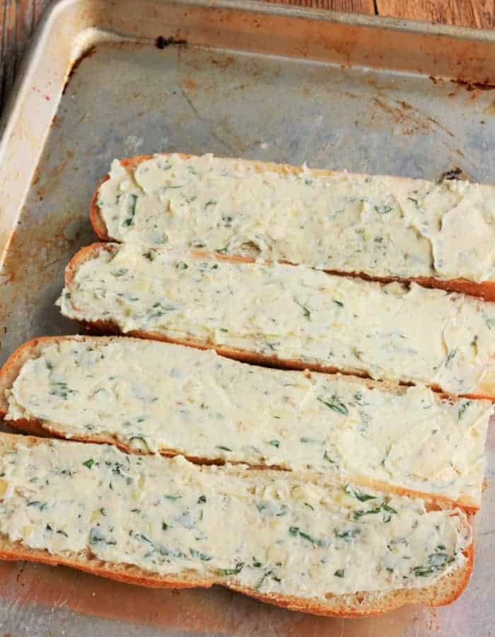 Four slices of cheesy garlic bread before baking