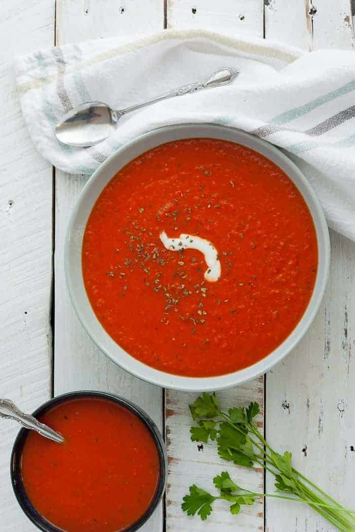 Two bowls of Whole30 tomato soup with parsley