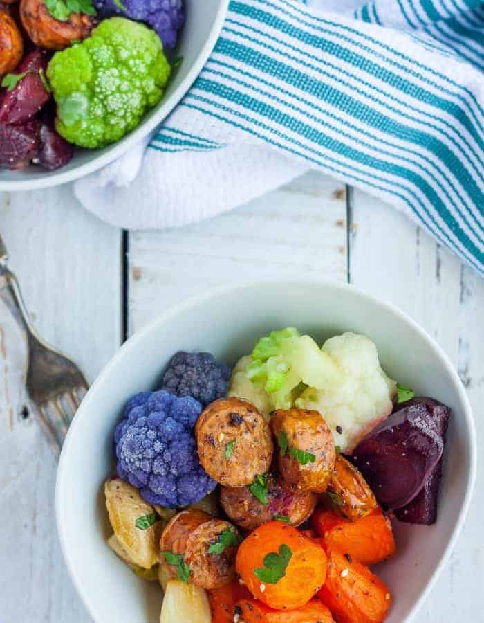 overhead photo of sheet pan sausage and veggies in a bowl