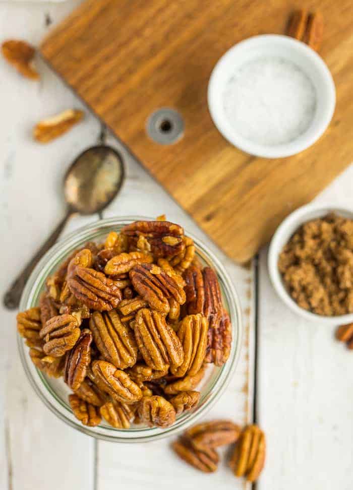 A glass bowl of stovetop candied pecans