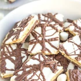 a plate of chocolate smores bark with mini marshmallows