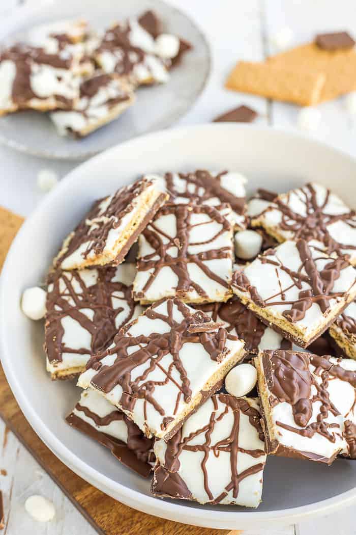 a plate of chocolate smores bark with mini marshmallows