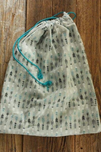 a cloth fabir shopping bag with blue drawstring