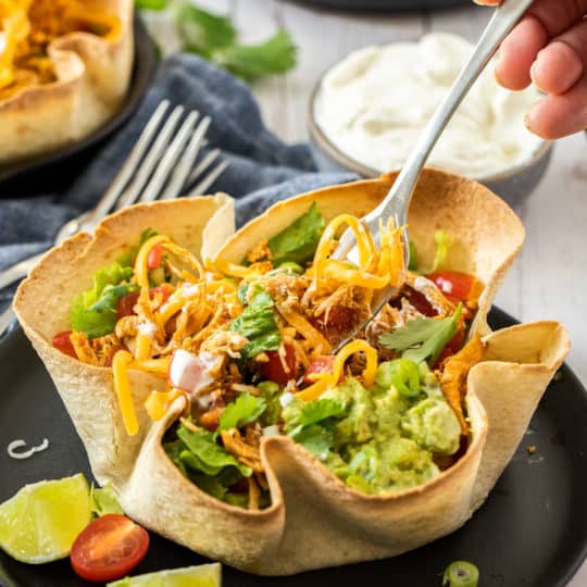 a fork in a baked tortilla bowl
