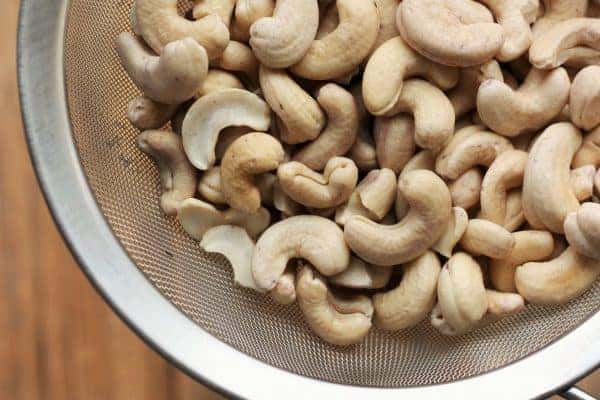 Soaked cashews in a strainer for a vegan custard tart | www.sustainablecooks.com