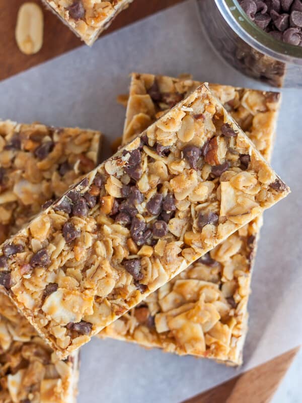 Three granola bars with chocolate chips on a piece of parchment