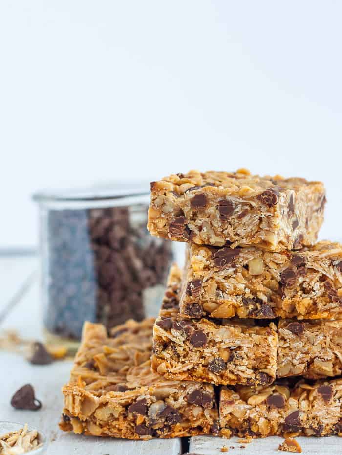 a stack of chocolate chip peanut butter granola bars against a white background