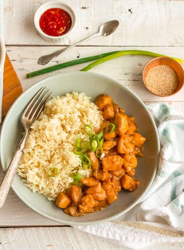 an overhead photo of a bowl of whole30 orange chicken and cauliflower rice
