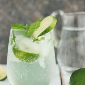 Glass filled with a virgin mojito with lime and mint