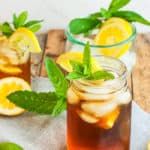 a mason jar of healthy sweet tea topped with lemons and mint