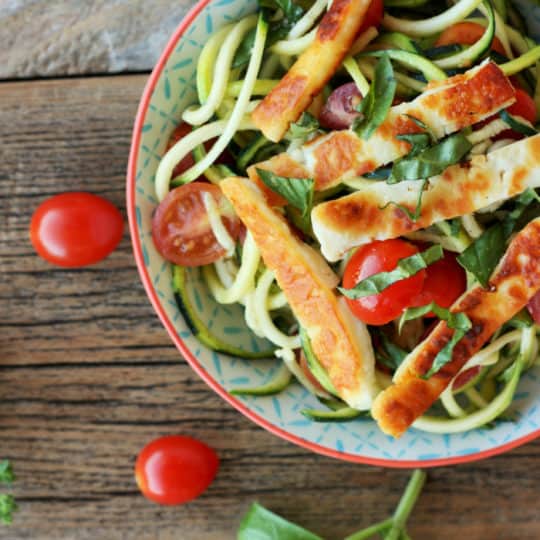 fried halloumi with tomatoes and zoodles in a bowl