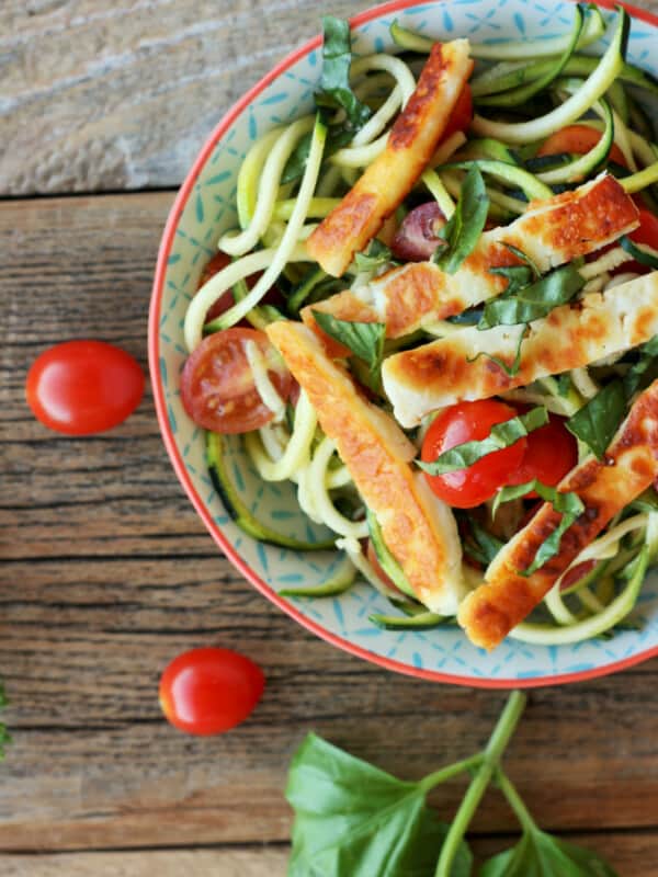 fried halloumi with tomatoes and zoodles in a bowl