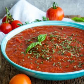 a bowl of crockpot spaghetti sauce with tomatoes and herbs
