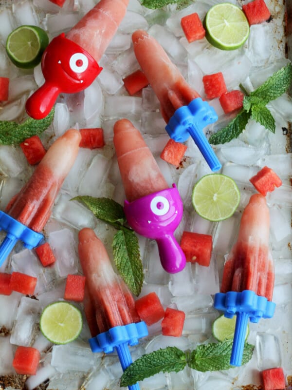 homemade watermelon popsicles on a tray of ice cubes with watermelon and mint