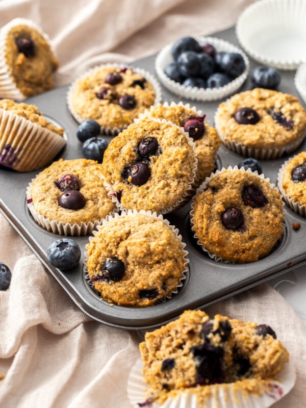 a muffin tray full of blueberry buttermilk muffins