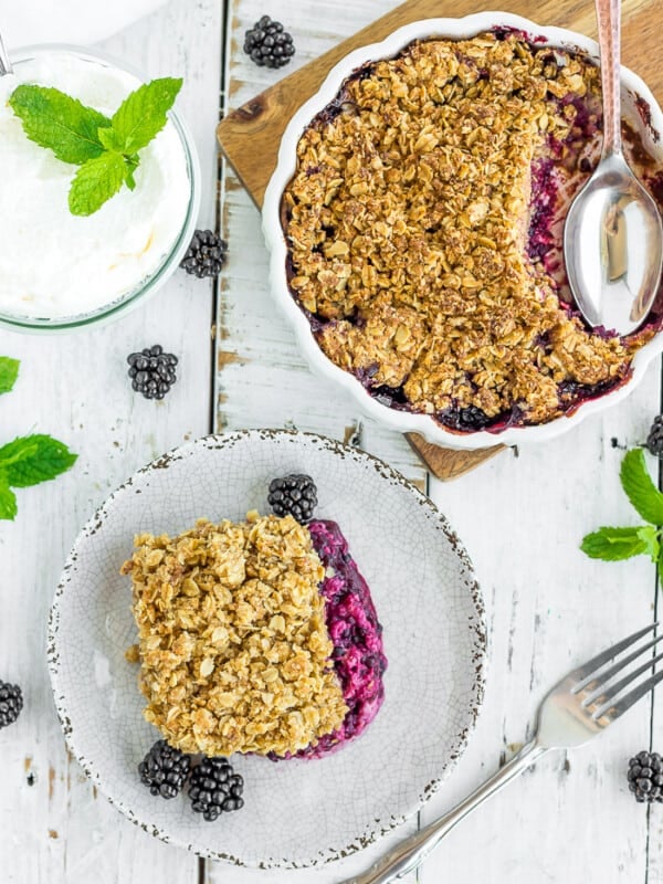 a plate and dish of blackberry crisp with an oatmeal topping