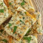 pieces of garlic bread on a beige plate