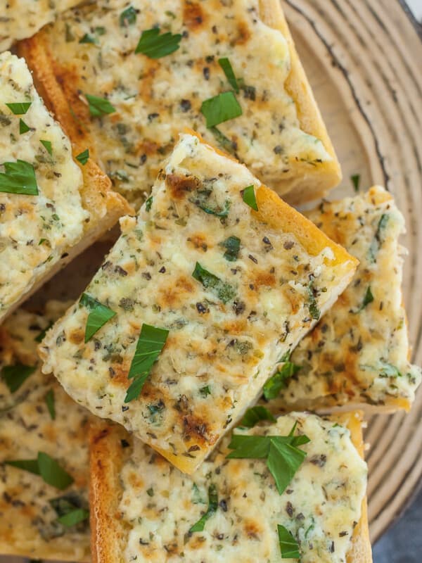 pieces of garlic bread on a beige plate