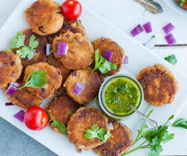 a platter of paleo salmon cakes with cilantro and chimichurri