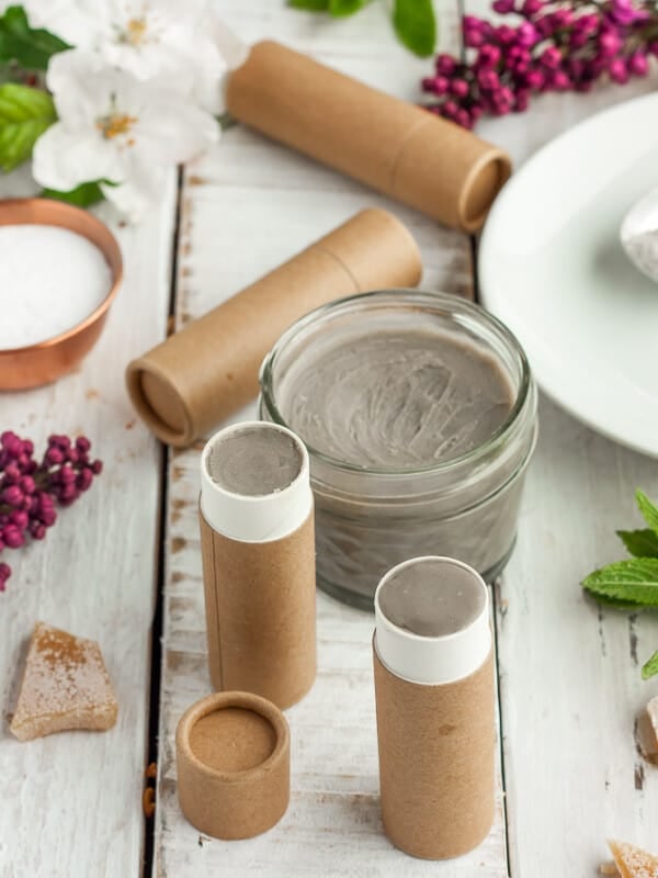 jars of deodorant with flowers, beeswax, and cardboard tubes