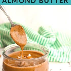 homemade cinnamon almond butter on a spoon with a jar