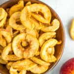 a wooden bowl of dried apples