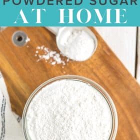 a glass bowl of powdered sugar on a cutting board